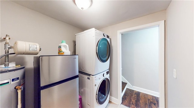 laundry area with stacked washer / dryer, wood-type flooring, and water heater