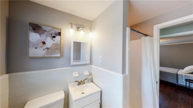 bathroom with vanity, toilet, a shower with shower curtain, and hardwood / wood-style floors