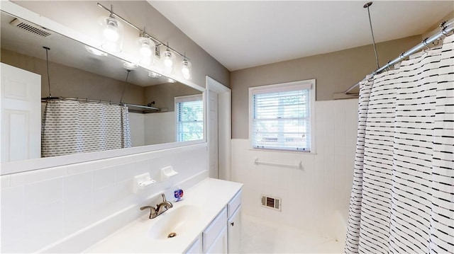 bathroom featuring vanity, decorative backsplash, and a shower with curtain