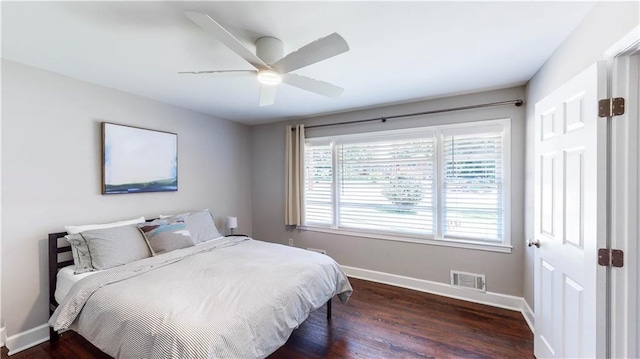 bedroom with dark wood-type flooring and ceiling fan