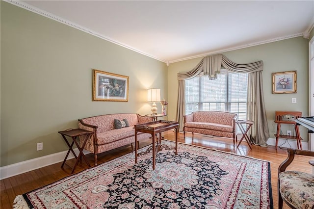 living room with crown molding, wood finished floors, and baseboards