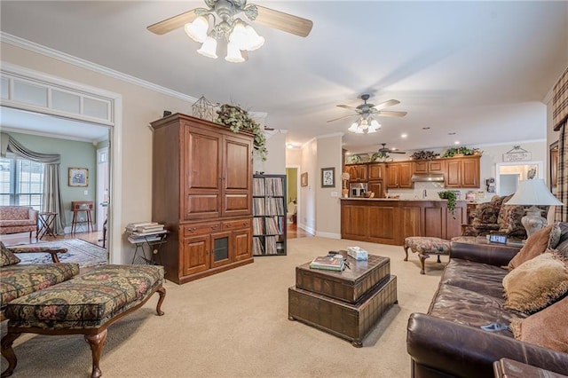 living area with a ceiling fan, light colored carpet, baseboards, and ornamental molding