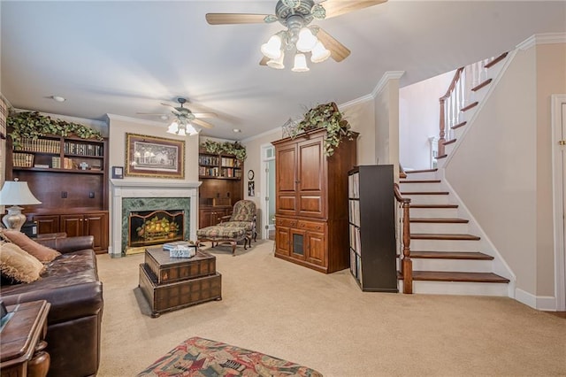 living room with stairs, a premium fireplace, light colored carpet, and crown molding