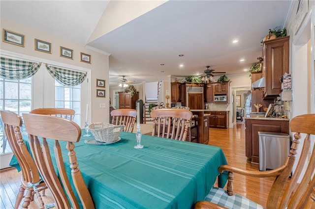 dining space with a ceiling fan, crown molding, recessed lighting, and light wood-style floors