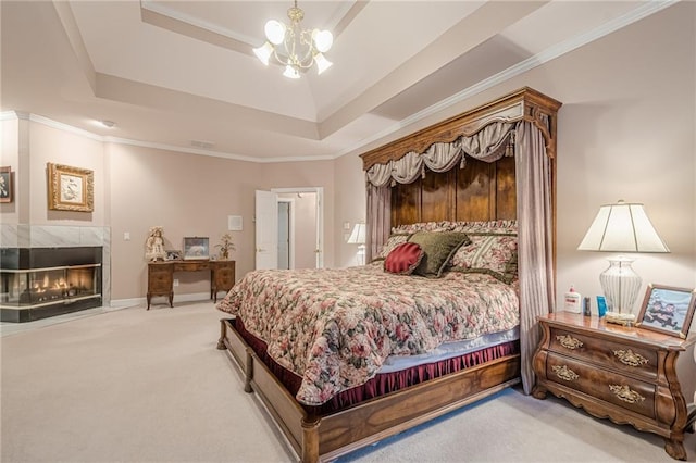 bedroom with a raised ceiling, crown molding, carpet, and a premium fireplace