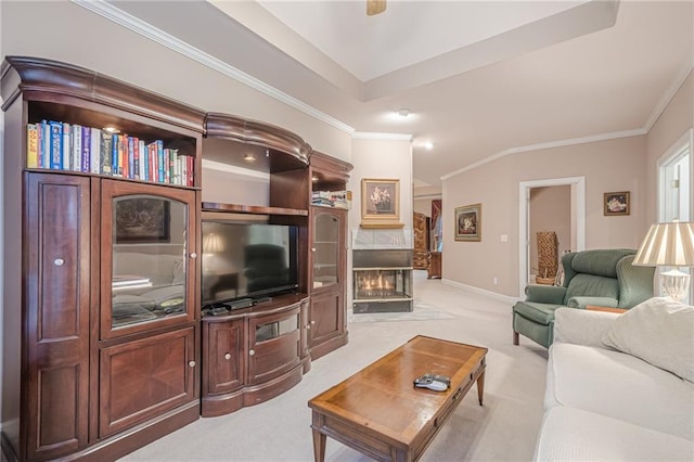 living area featuring baseboards, light colored carpet, a fireplace, and crown molding