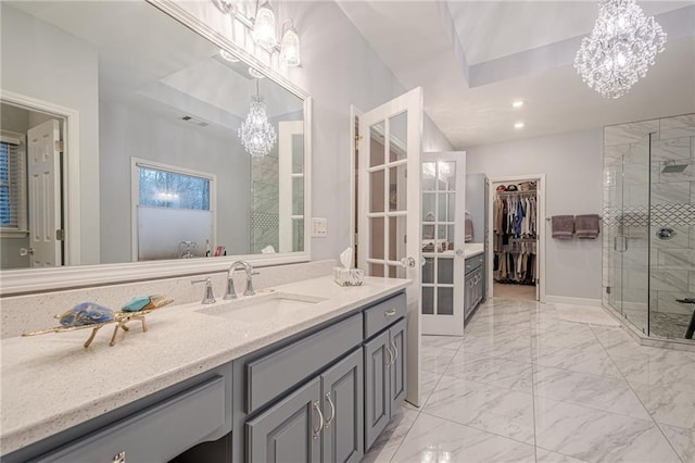 bathroom with recessed lighting, a shower stall, marble finish floor, and an inviting chandelier