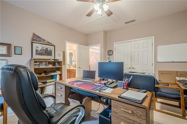 home office with visible vents, attic access, and carpet flooring