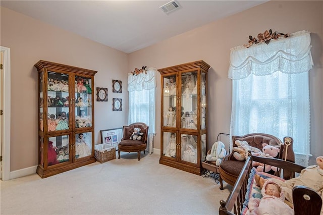 sitting room featuring visible vents, baseboards, and carpet flooring