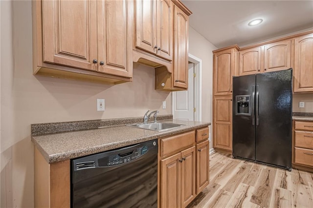 kitchen featuring recessed lighting, light brown cabinetry, a sink, black appliances, and light wood-type flooring