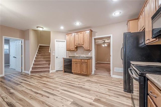 kitchen with light brown cabinetry, recessed lighting, black appliances, and light wood-type flooring