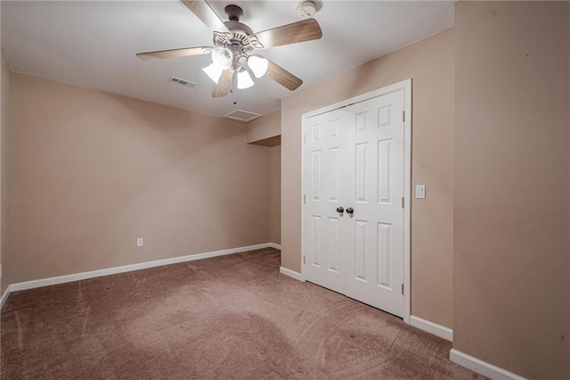 unfurnished bedroom with a closet, visible vents, baseboards, and carpet