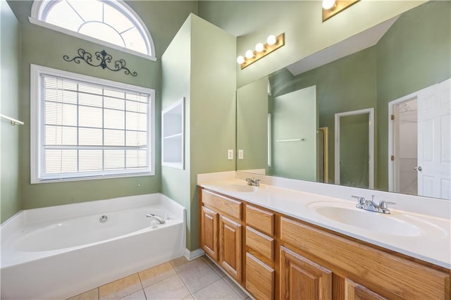 bathroom featuring a tub to relax in, tile patterned flooring, and vanity