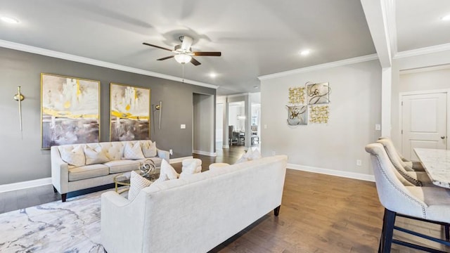 living room featuring dark hardwood / wood-style flooring, crown molding, and ceiling fan