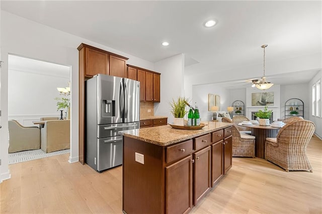 325 Cranbrooke Cir, Suwanee, GA 30024 - kitchen featuring stainless steel fridge, light wood-style flooring, a center island, open floor plan, and recessed lighting