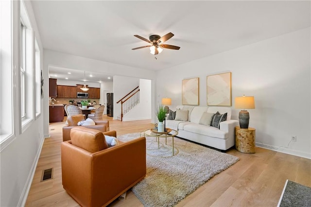 325 Cranbrooke Cir, Suwanee, GA 30024 - living room with a ceiling fan, stairs, light wood-type flooring, recessed lighting, and plenty of natural light