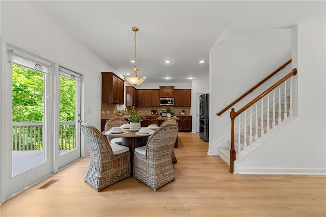 325 Cranbrooke Cir, Suwanee, GA 30024 - dining area featuring light wood-style flooring, recessed lighting, and stairway