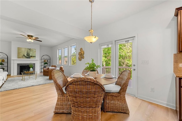 325 Cranbrooke Cir, Suwanee, GA 30024 - dining area with light wood finished floors, a premium fireplace, and ceiling fan