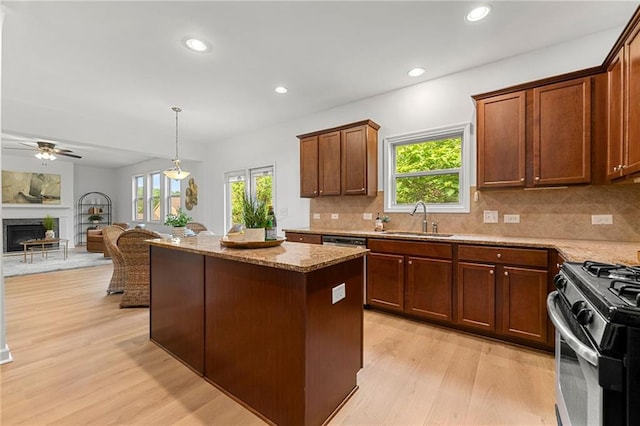 325 Cranbrooke Cir, Suwanee, GA 30024 - kitchen featuring light wood-type flooring, stainless steel appliances, plenty of natural light, a fireplace, and recessed lighting