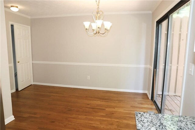 unfurnished bedroom featuring crown molding, wood-type flooring, and a chandelier