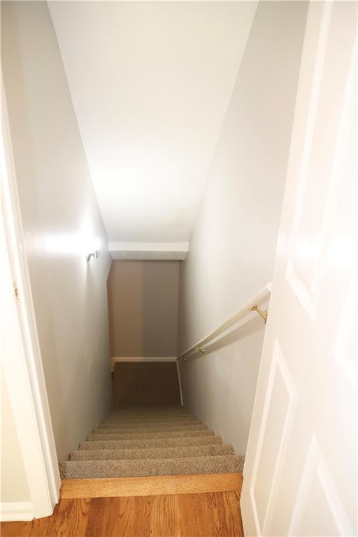 stairs with hardwood / wood-style floors