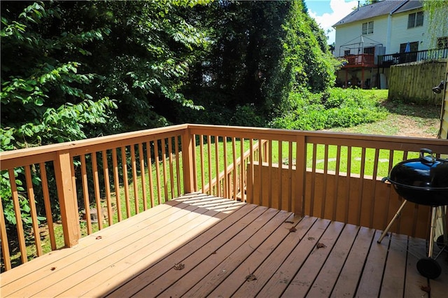 wooden deck featuring a grill