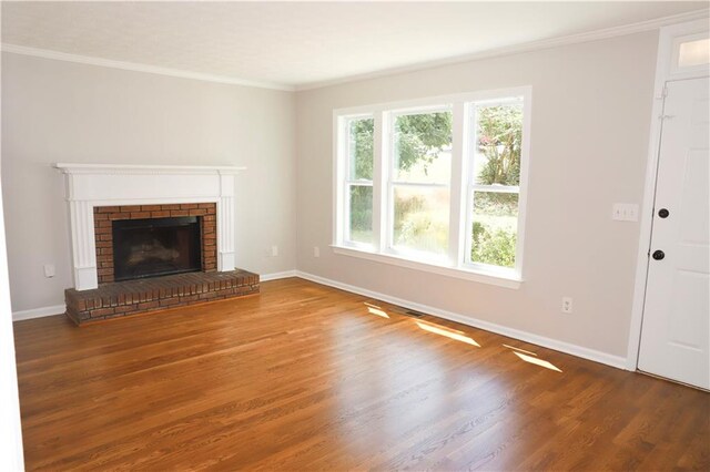 unfurnished living room featuring a fireplace, dark hardwood / wood-style flooring, and ornamental molding