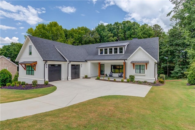 modern farmhouse style home with a garage, covered porch, and a front lawn