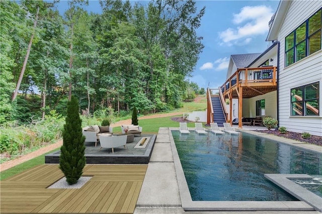 view of pool with an outdoor living space and a deck