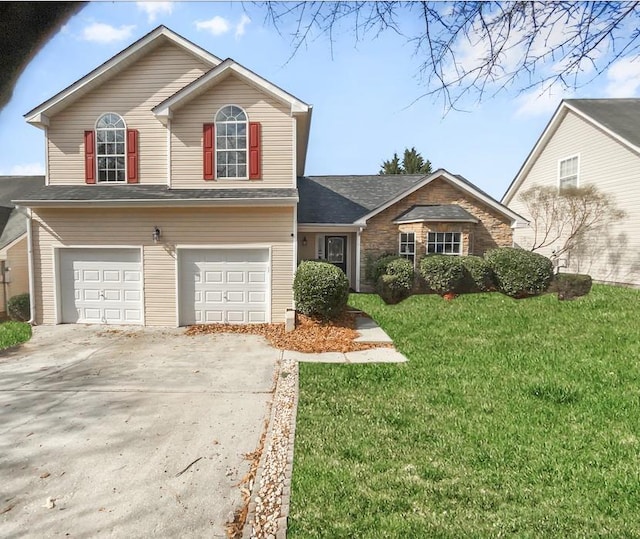 view of front facade with driveway, a front lawn, and an attached garage