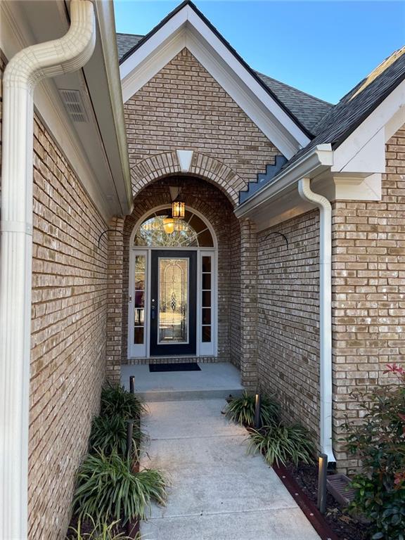 doorway to property featuring brick siding