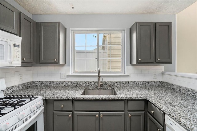 139 W Oaks Pl, Woodstock, GA 30188 - kitchen featuring white appliances, decorative backsplash, gray cabinets, and light stone counters