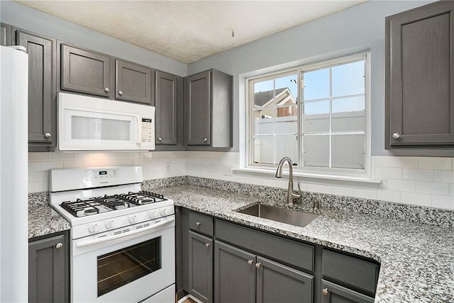 139 W Oaks Pl, Woodstock, GA 30188 - kitchen featuring white appliances, gray cabinetry, tasteful backsplash, and light stone countertops