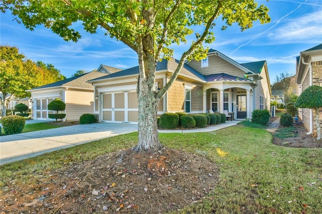 view of front of property with a garage and a front lawn