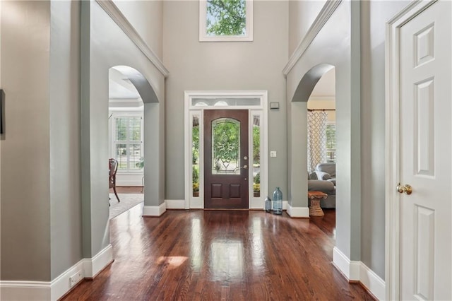 3235 Munsey Ct, Cumming, GA 30041 - foyer entrance with arched walkways, a high ceiling, and wood finished floors