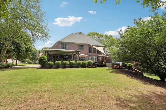 3235 Munsey Ct, Cumming, GA 30041 - back of house with a chimney, a lawn, and brick siding