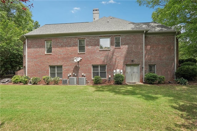 3235 Munsey Ct, Cumming, GA 30041 - rear view of house with a yard, brick siding, and a chimney