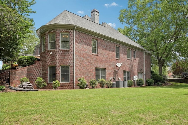 3235 Munsey Ct, Cumming, GA 30041 - back of property with a yard, brick siding, a chimney, and roof with shingles