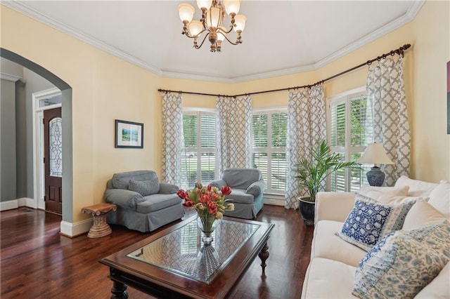 3235 Munsey Ct, Cumming, GA 30041 - living area with arched walkways, healthy amount of natural light, a chandelier, crown molding, and wood finished floors