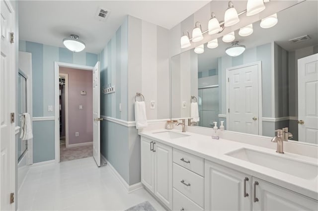 3235 Munsey Ct, Cumming, GA 30041 - bathroom featuring a shower with door, double vanity, tile patterned floors, and a closet