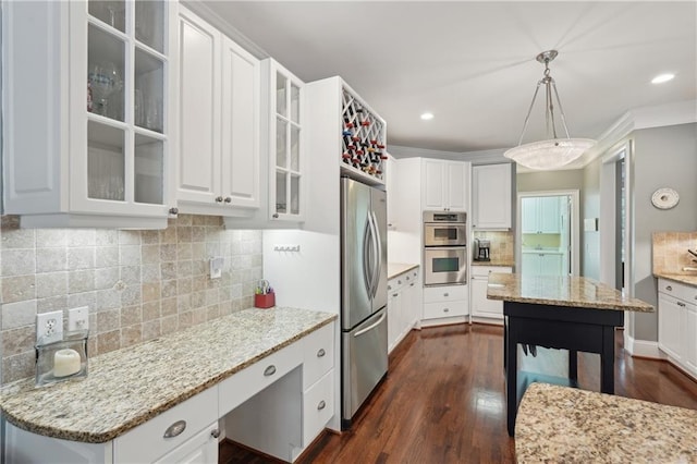 3235 Munsey Ct, Cumming, GA 30041 - kitchen with stainless steel appliances, white cabinetry, light stone countertops, dark wood finished floors, and tasteful backsplash