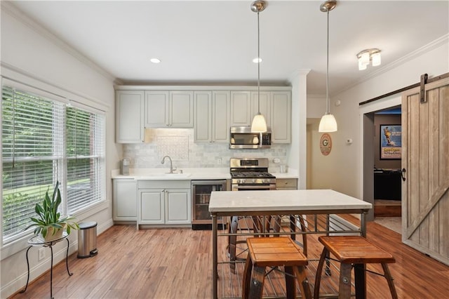 3235 Munsey Ct, Cumming, GA 30041 - kitchen with stainless steel appliances, wine cooler, a barn door, ornamental molding, and decorative backsplash