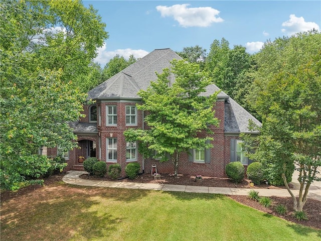 3235 Munsey Ct, Cumming, GA 30041 - view of front facade featuring a front yard, brick siding, and a shingled roof