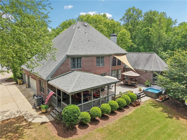 3235 Munsey Ct, Cumming, GA 30041 - rear view of house with a hot tub, a chimney, driveway, a yard, and a shingled roof