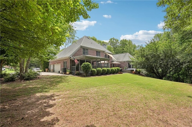 3235 Munsey Ct, Cumming, GA 30041 - back of property featuring an attached garage, brick siding, a lawn, and driveway