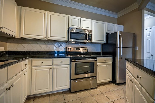 kitchen with light tile patterned floors, white cabinets, appliances with stainless steel finishes, decorative backsplash, and crown molding