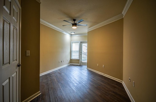 unfurnished room with baseboards, a ceiling fan, dark wood-style floors, a textured ceiling, and crown molding