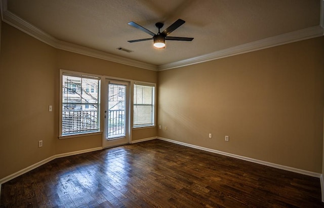 empty room featuring ceiling fan, ornamental molding, dark wood-style flooring, and visible vents