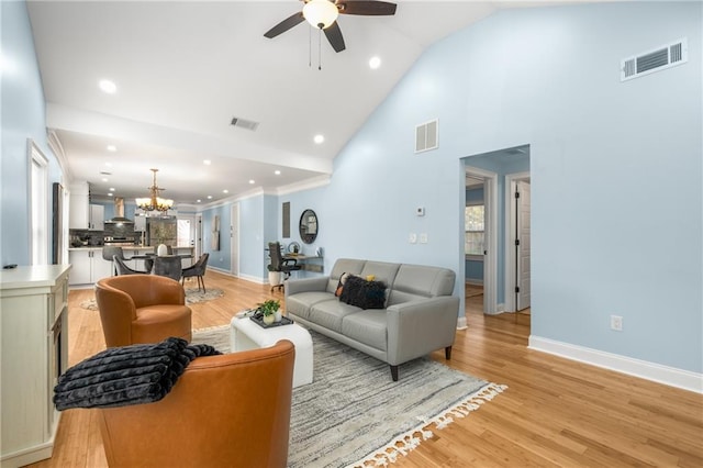 living room with light wood-type flooring, visible vents, and a healthy amount of sunlight