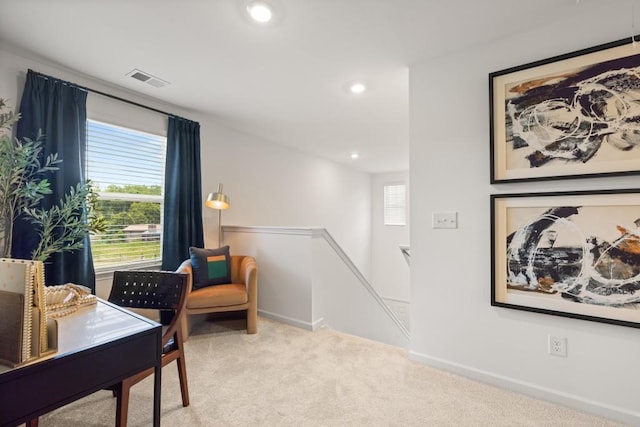 living area featuring light colored carpet